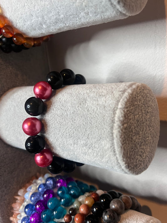 Black bracelet with pink beads