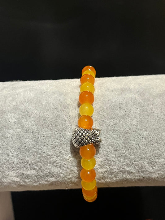Yellow and orange bracelet with silver pineapple charm