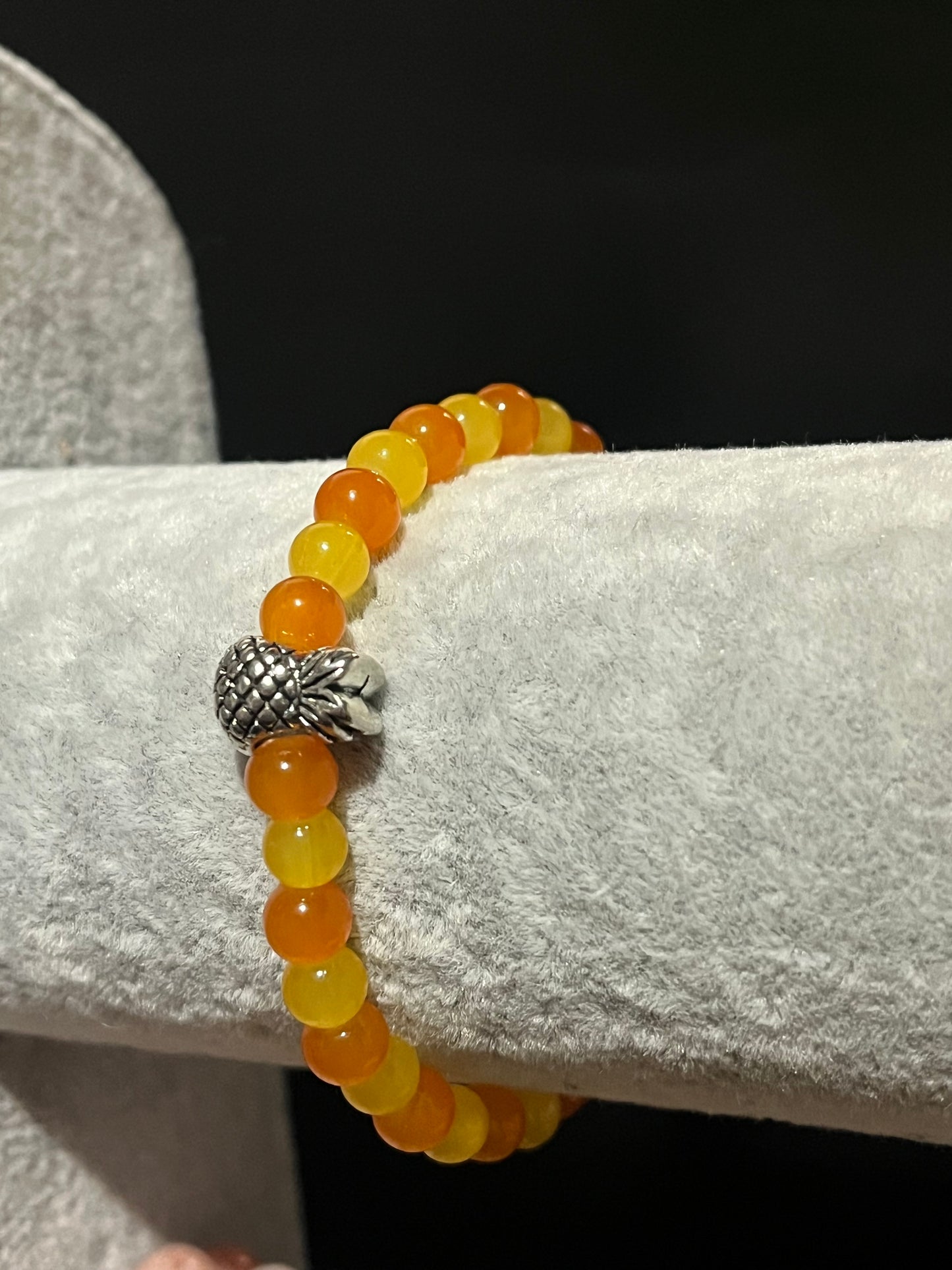 Yellow and orange bracelet with silver pineapple charm
