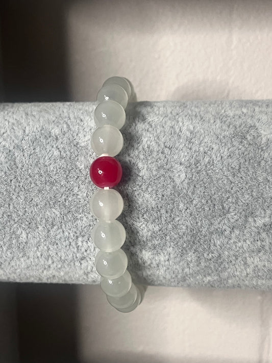 White Quarz crystal with red glass bead