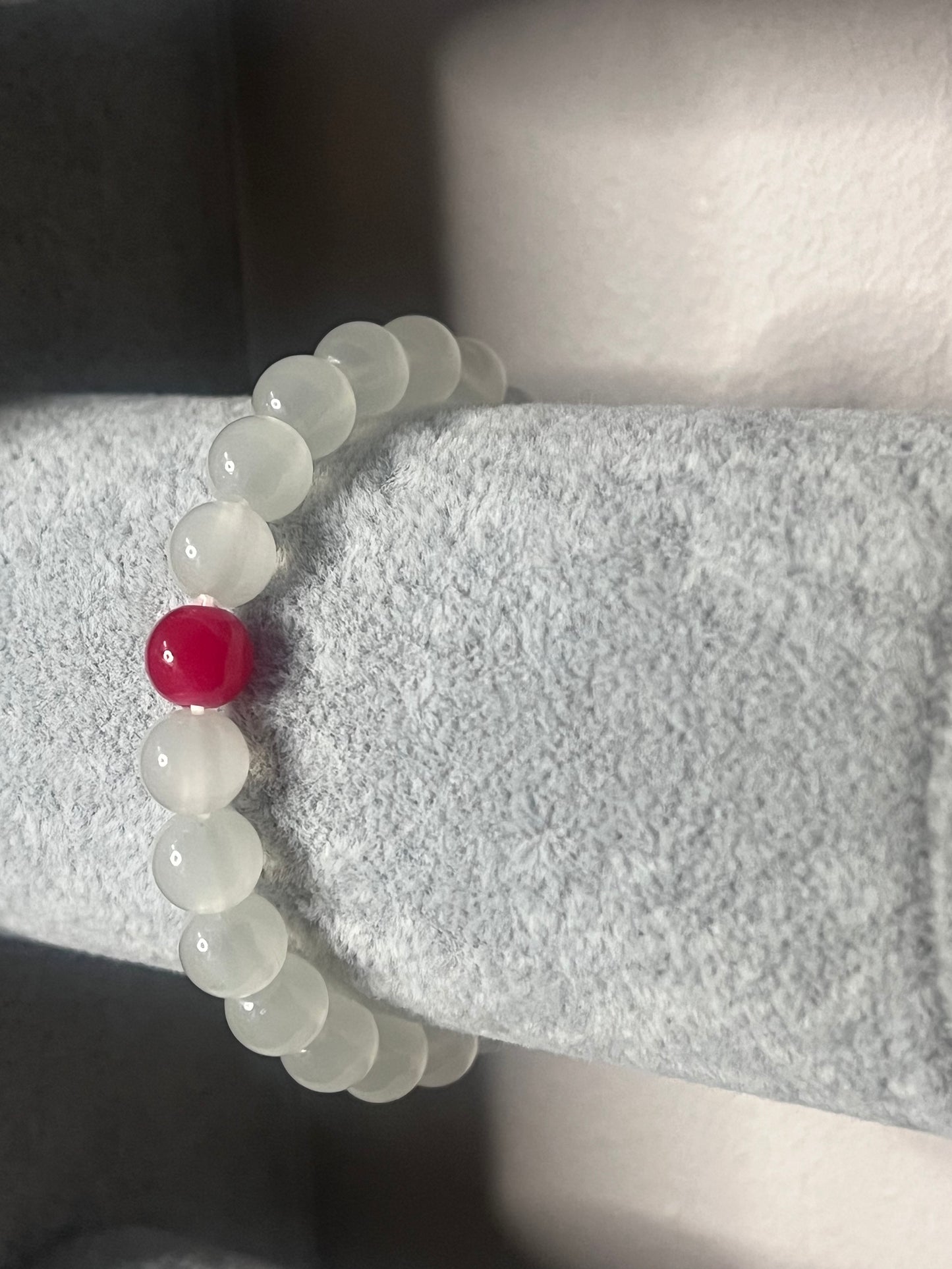 White Quarz crystal with red glass bead