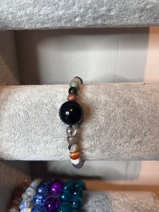Small multi coloured crystal with large black bead