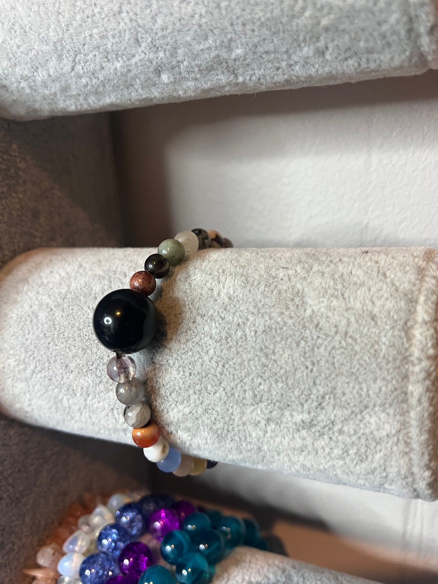Small multi coloured crystal with large black bead