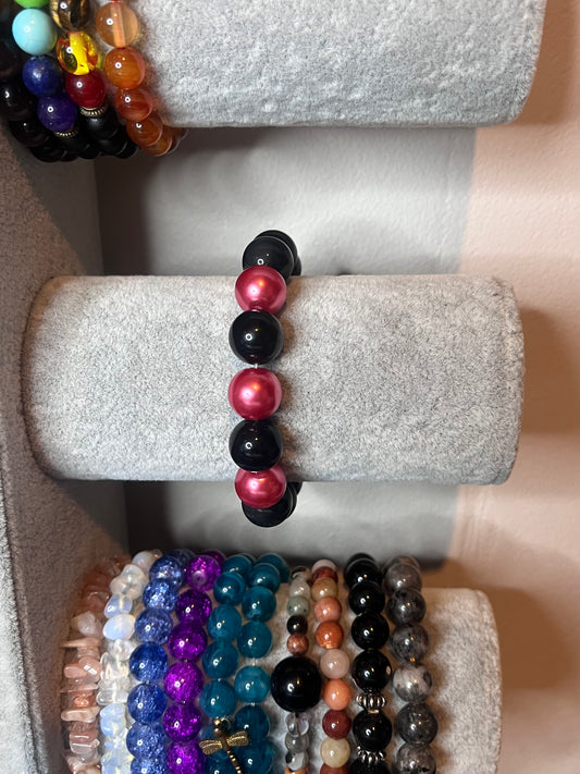 Black bracelet with pink beads