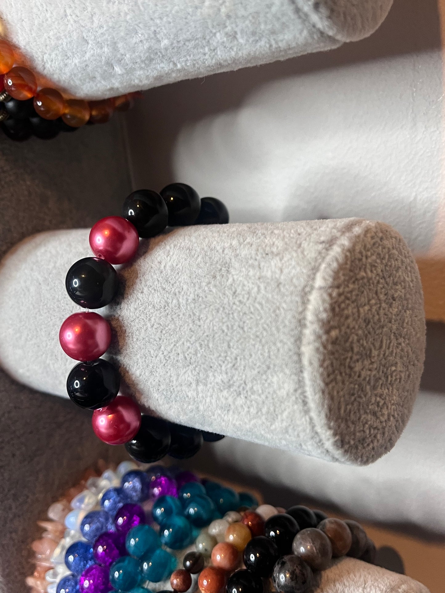 Black bracelet with pink beads